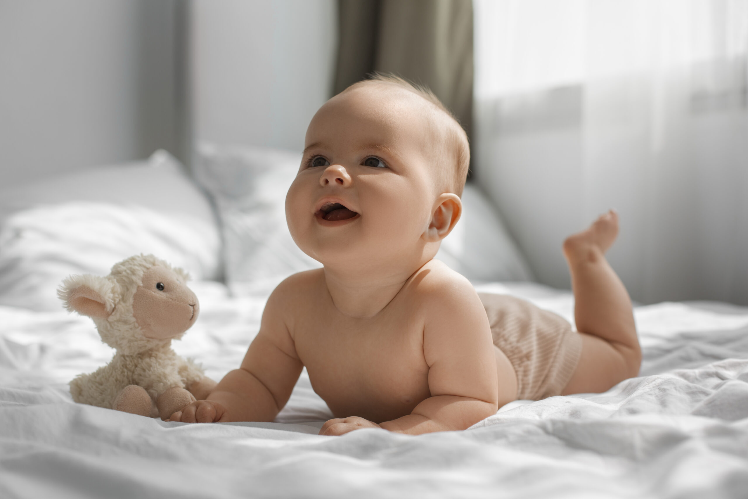 baby with stuffed animal scaled В Мордовии появятся новые меры поддержки молодых семей